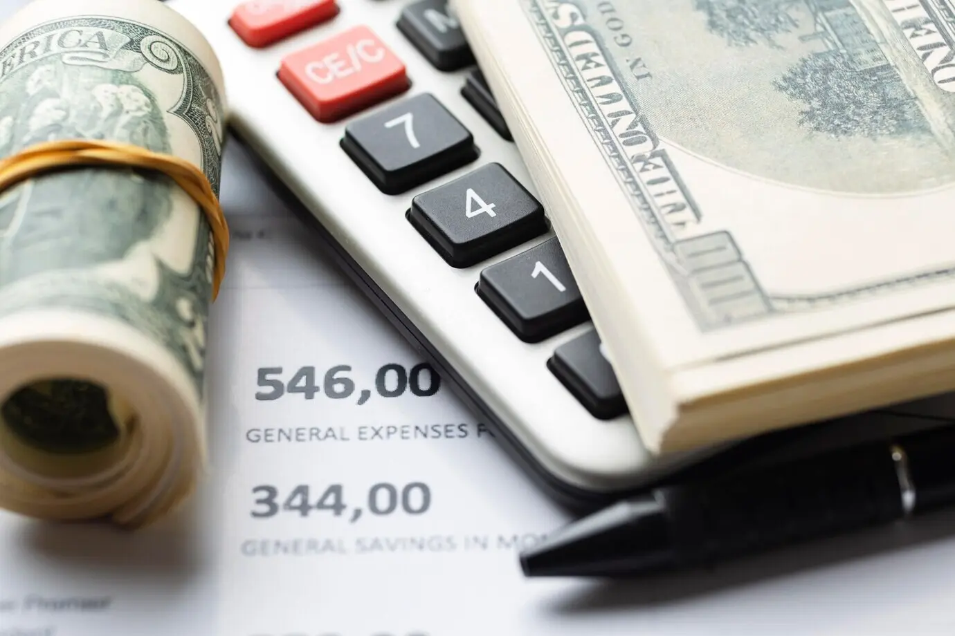 Overhead view of cash and a calculator